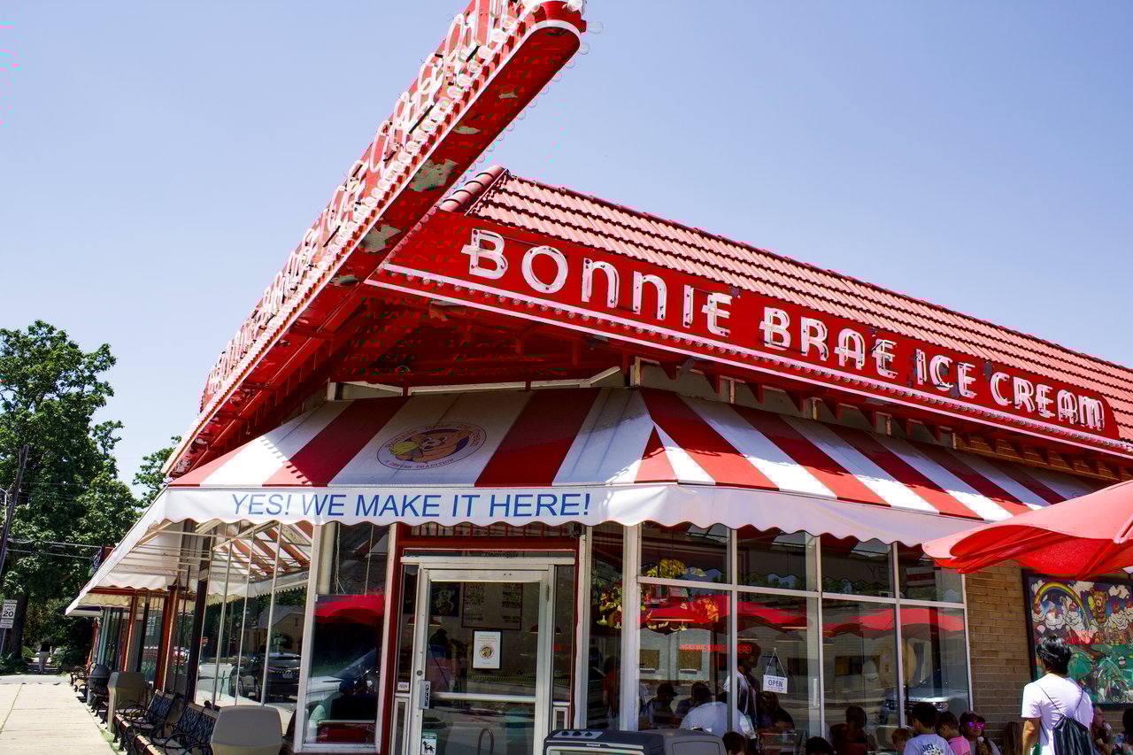 Alt text: Exterior of Bonnie Brae Ice Cream shop with red and white awnings in Denver.