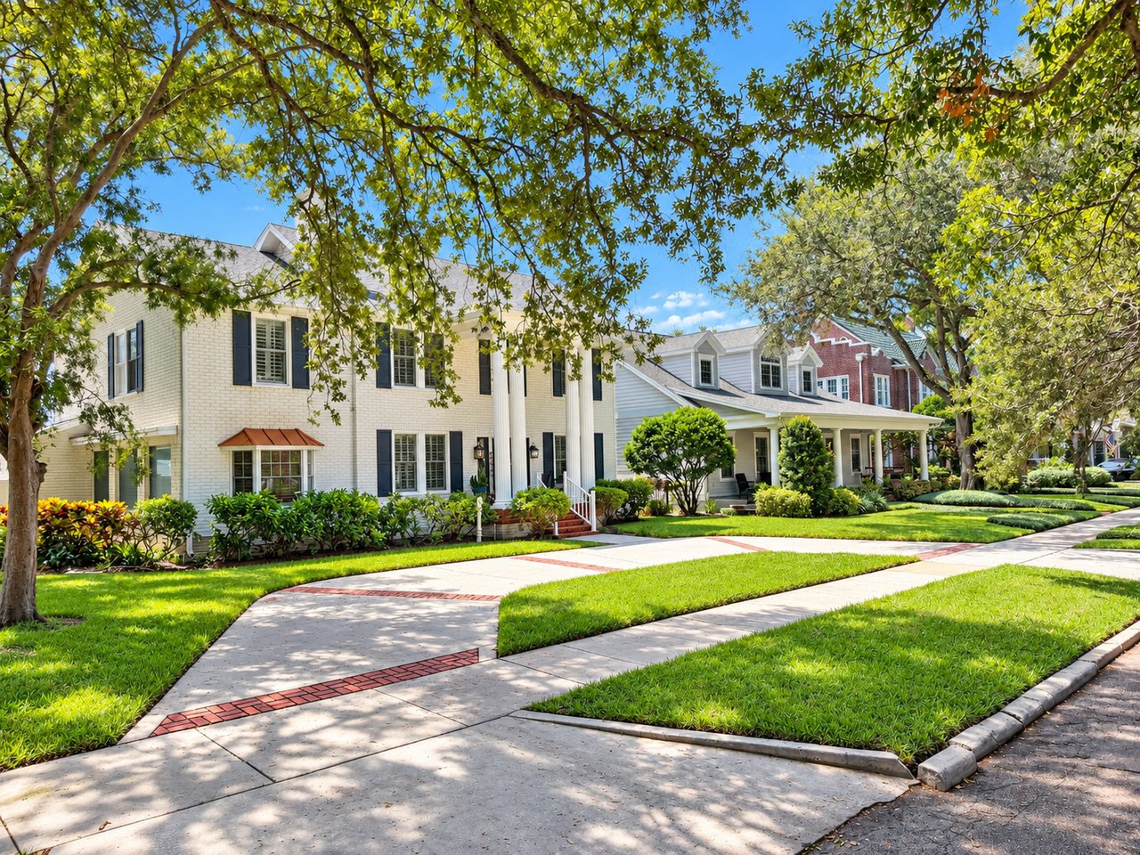New Suburb Beautiful homes line a leafy street with broad sidewalks and manicured lawns.