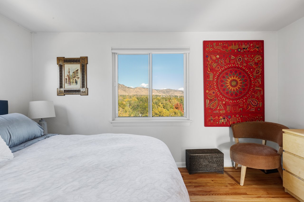Bedroom sitting corner at 2003 Balsam Drive with a leather chair and a window looking out to the foothills