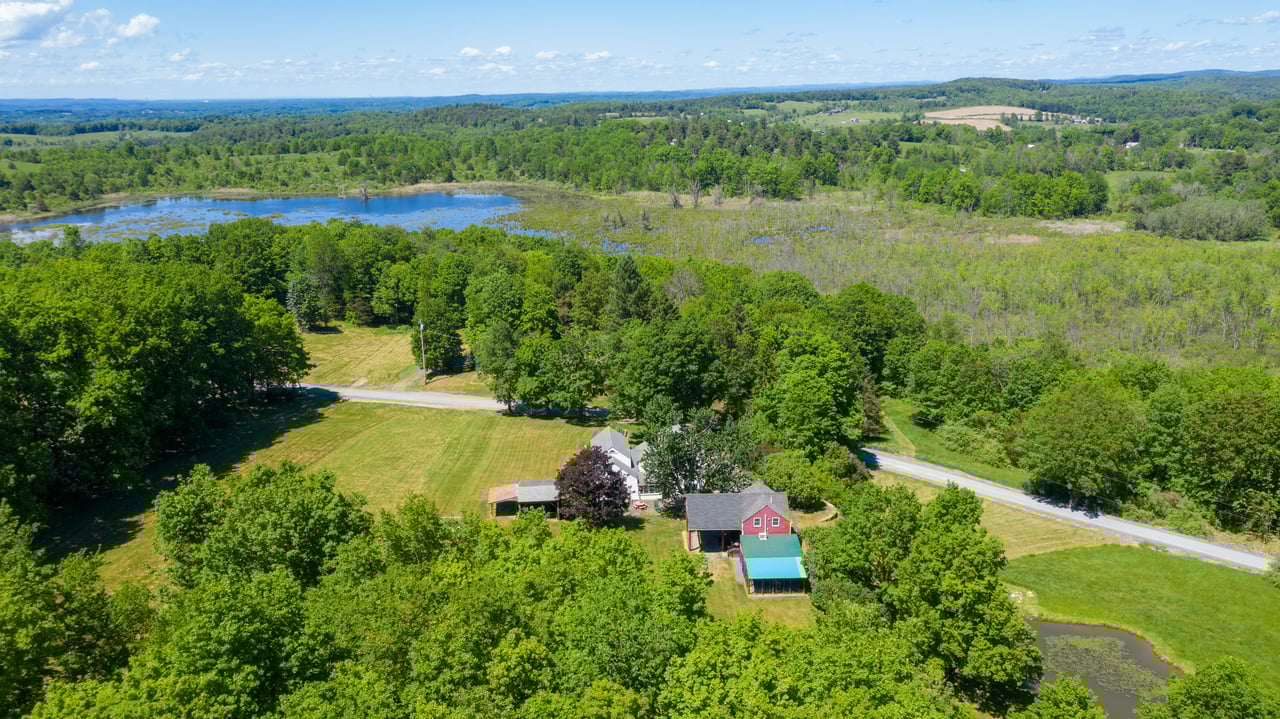 Aerial view of a historic home in Columbia County, NY during the spring 2026 real estate season.
