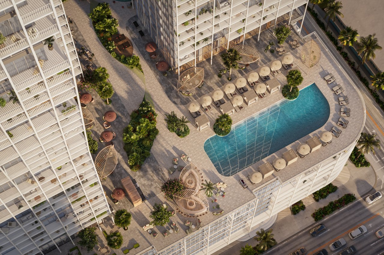 Ombelle rooftop pool deck with a curved swimming pool, lounge chairs, cabanas, and tropical landscaping.