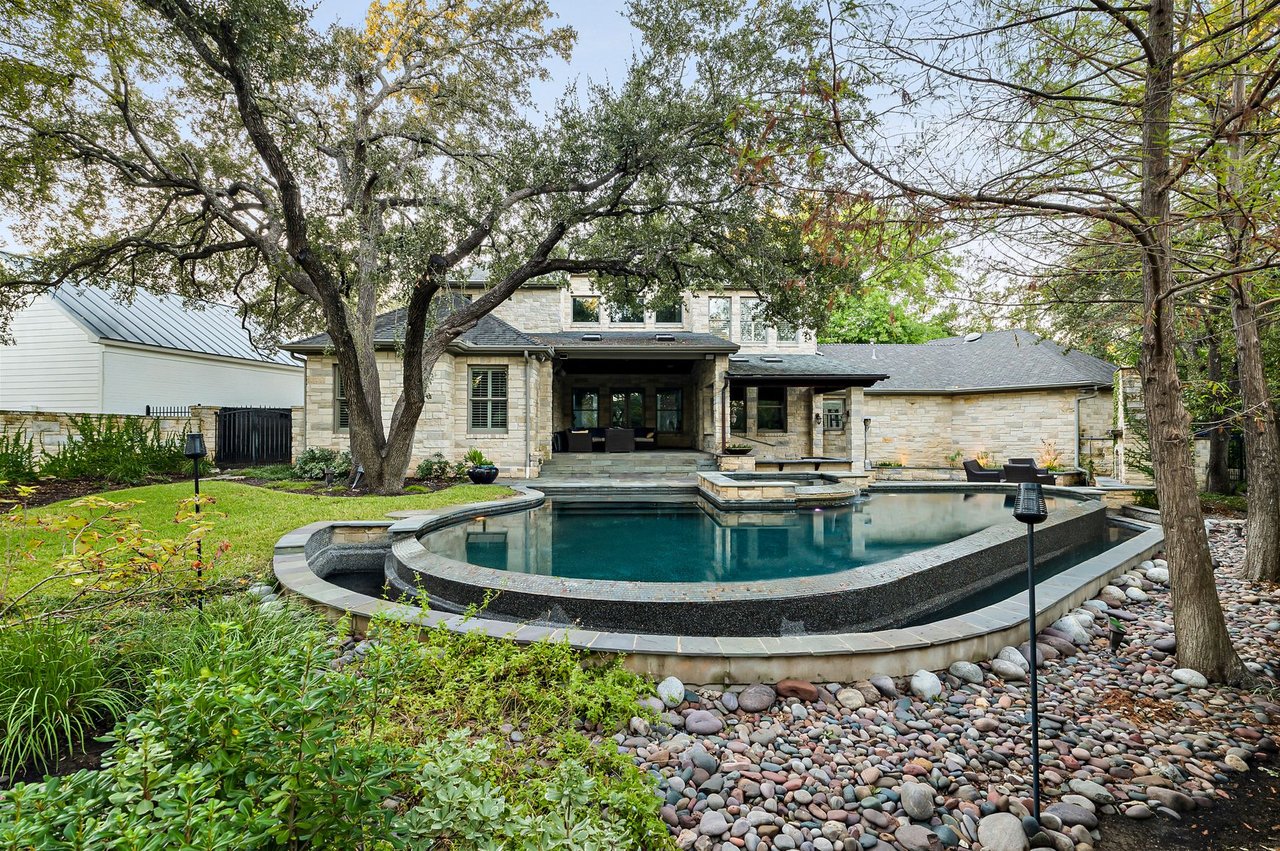Backyard pool and spa surrounded by mature oak trees at 5902 Saratoga Cove, Davenport Ranch, Austin, Texas, built by John Luce.