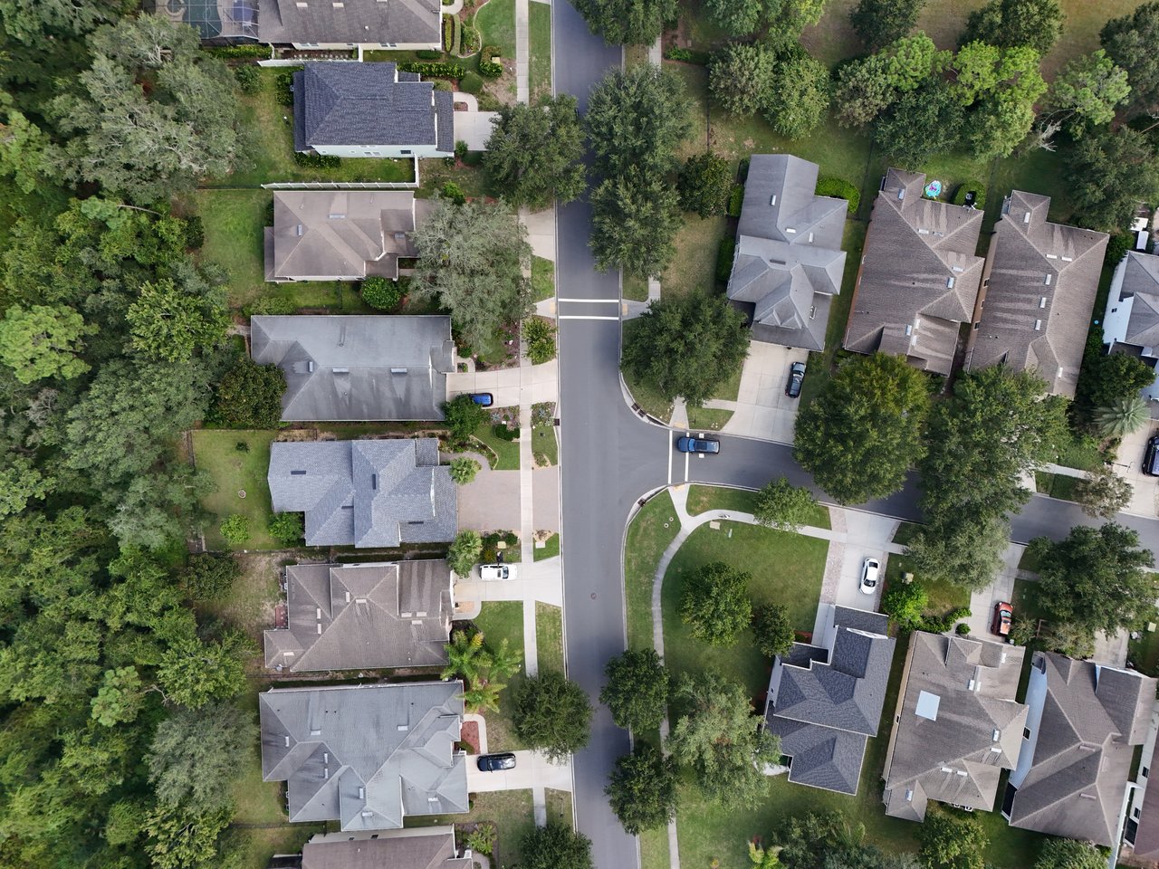Aerial view of Greenleaf Village homes along a tree-lined street and cul-de-sac.
