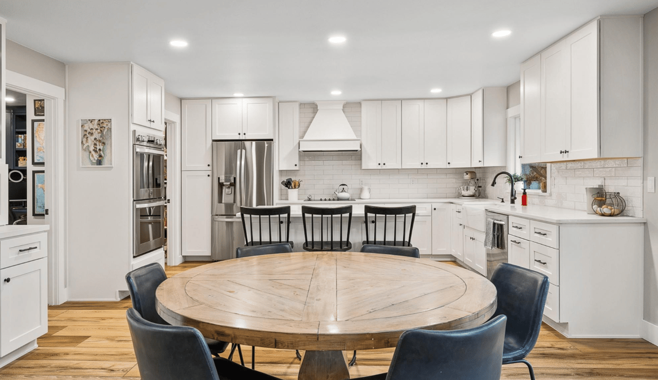 Warm hard wood floors and tasteful white cabinets in luxury home in Richland