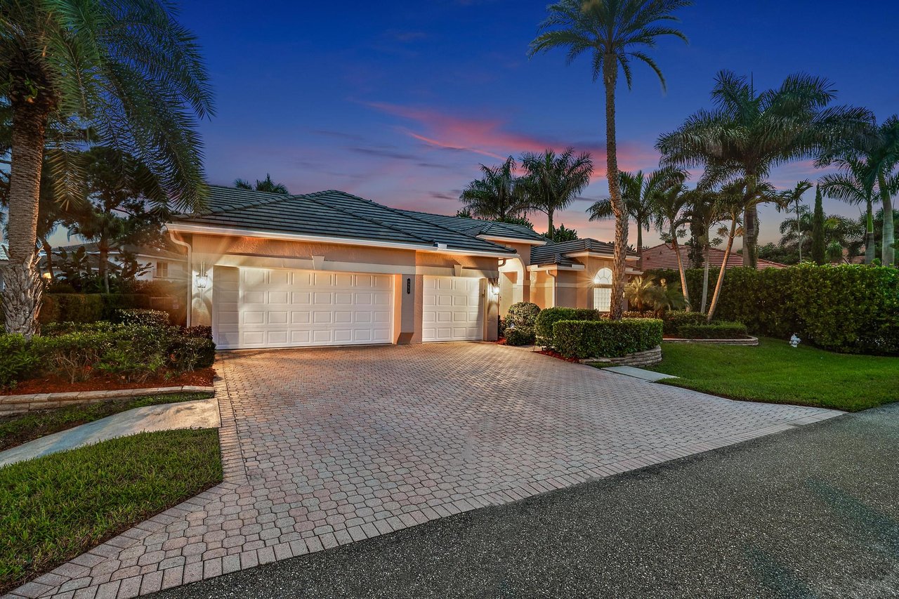 Screen-enclosed pool and backyard of a single-story home in North Passage, a gated community on the Loxahatchee River near Jupiter and Tequesta, Florida