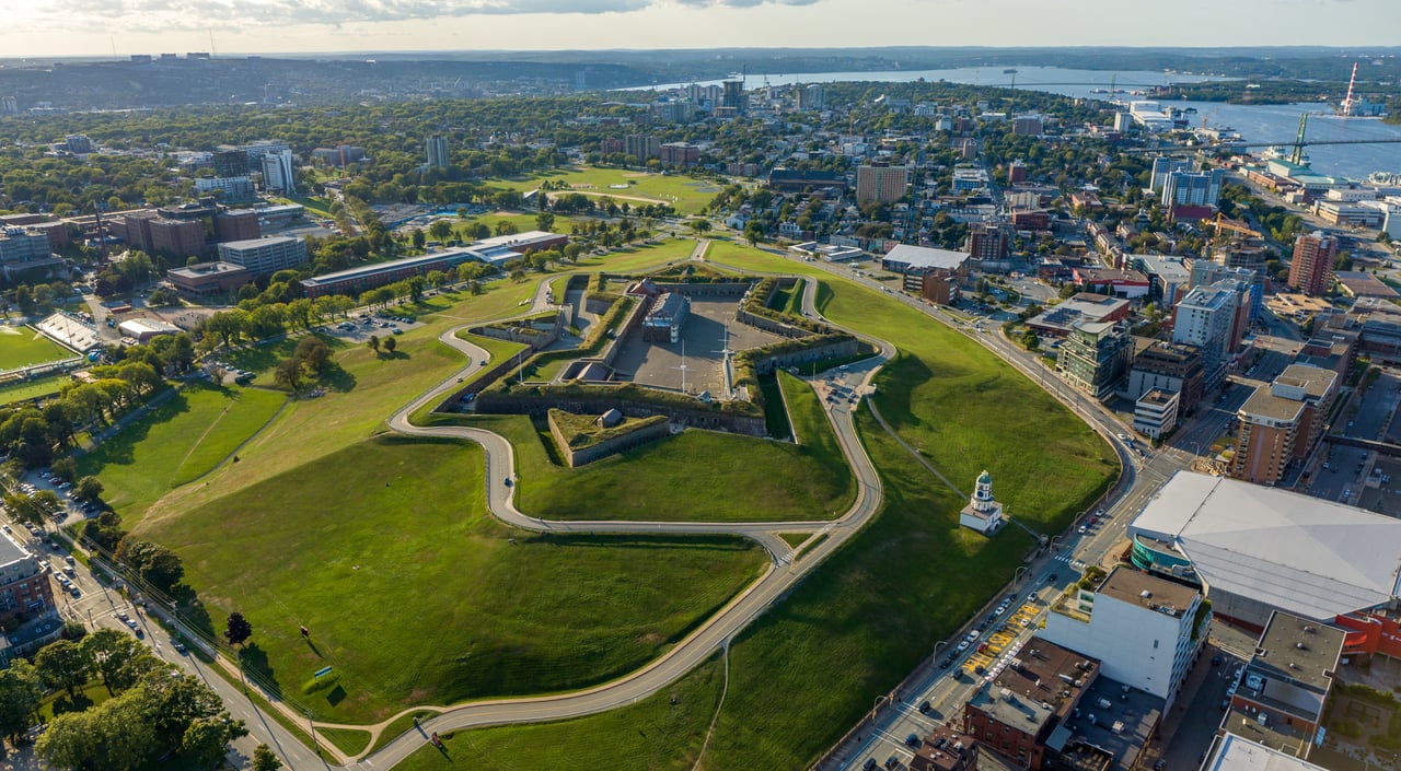 Halifax Citadel’s star-shaped fort and green grounds, with downtown buildings and the harbor beyond.
