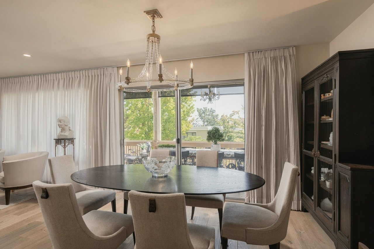 Elegantly designed dining and living area at 2501 Golden Rain Road, Rossmoor Walnut Creek with chandelier and tailored drapery.