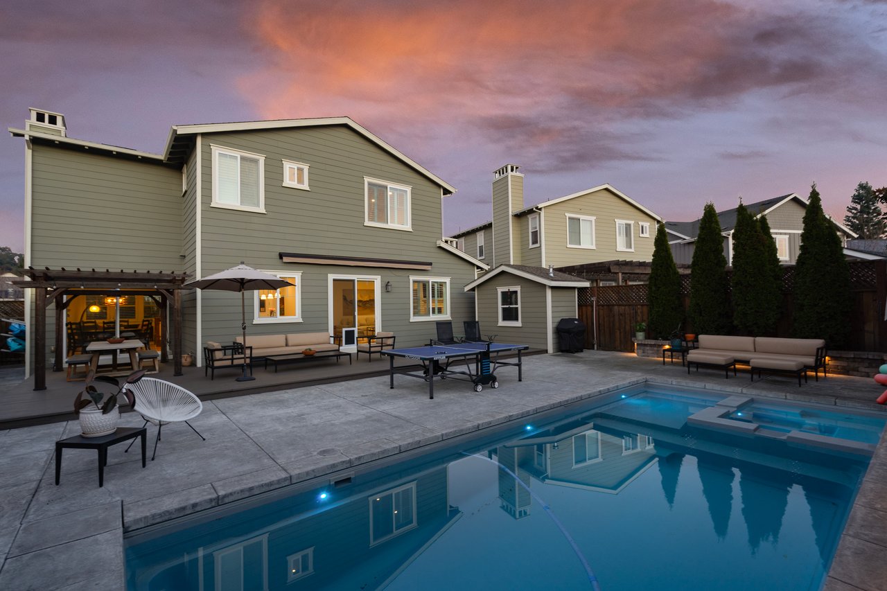 altwater backyard pool with attached spa and pergola-covered dining area