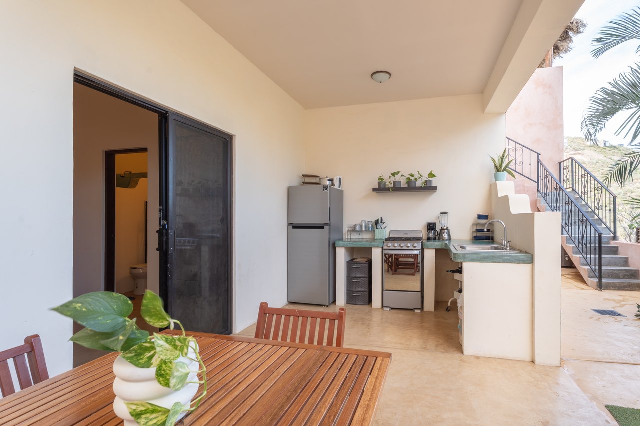 Outdoor kitchen and patio at The Studio House in Villas de Cerritos with terrace seating and garden views in Cerritos, Baja California Sur.