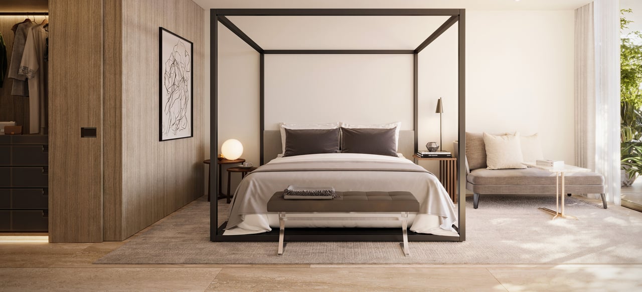 Bedroom with a black-framed canopy bed, built-in wood wardrobes, and a window-side sitting area.