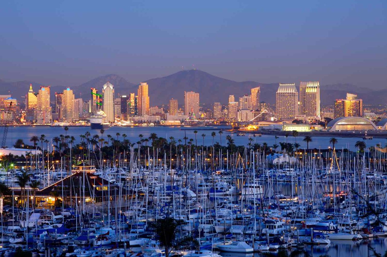 View from Point Loma overlooking a marina across San Diego Bay toward the downtown San Diego skyline, showcasing the waterfront lifestyle that defines this historic coastal community.