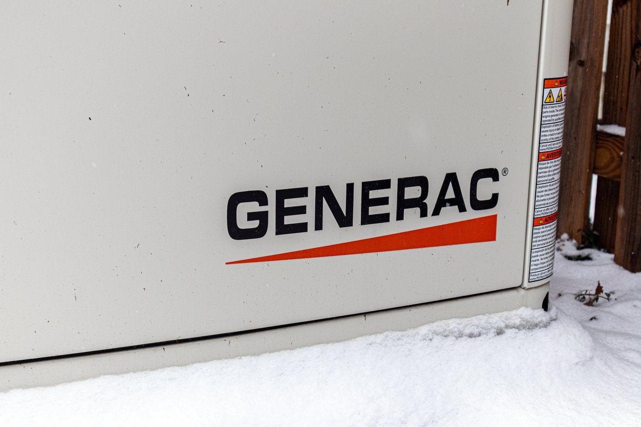 Standby Generac backup generator installed beside a luxury home in Incline Village, Nevada surrounded by pine trees