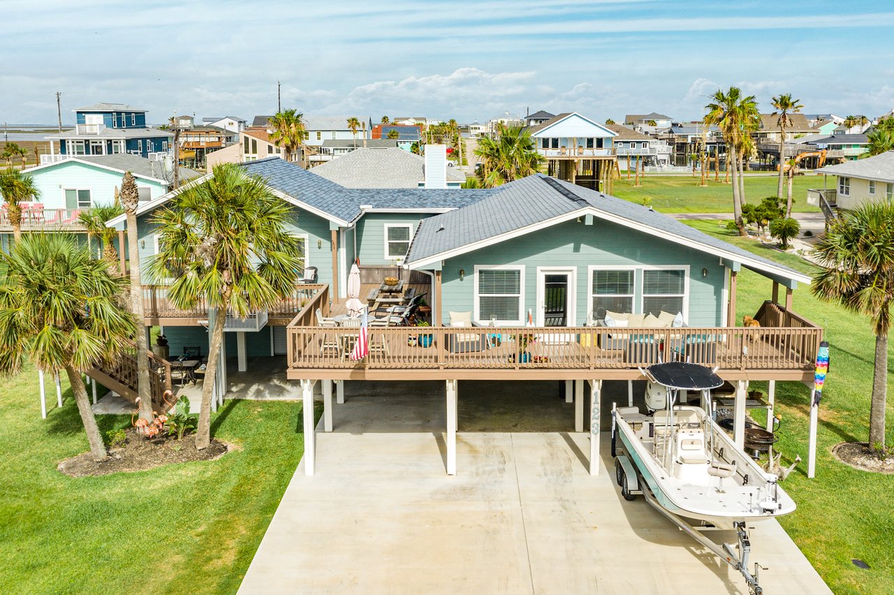 Outdoor deck at a Freeport waterfront home with space for seating and parties, featuring a lift for easy boat access and coastal entertaining.