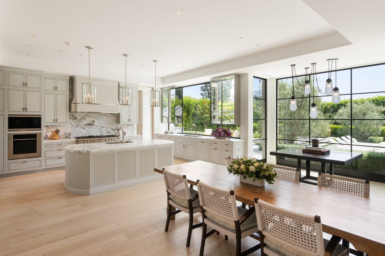 Luxury open-concept kitchen with marble island and floor-to-ceiling windows in modern Bay Area home