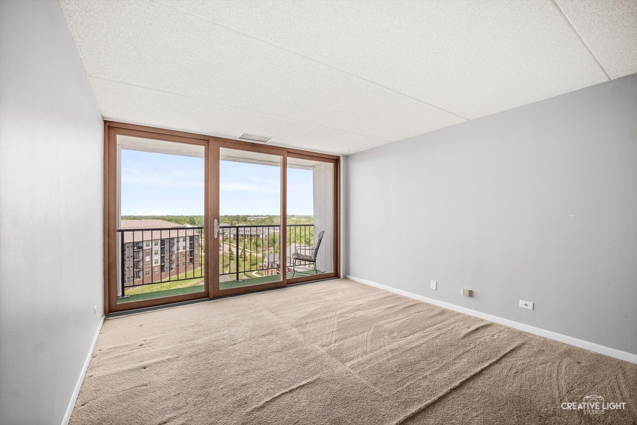 Primary bedroom with walk-in closet at 2015 S Finley Road Unit 1104 Cove Landing Lombard IL 60148