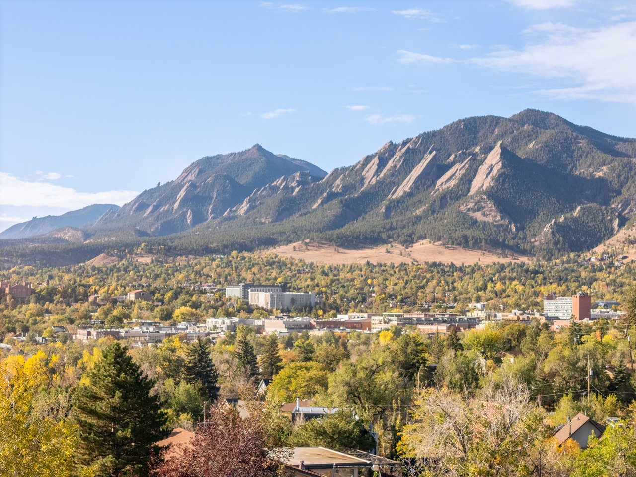 View of the Flatirons and downtown Boulder in fall colors from the area around 2003 Balsam Drive