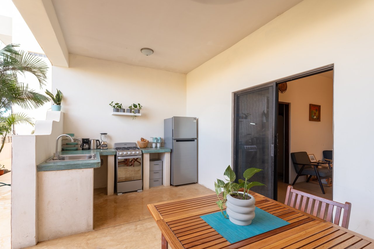 Outdoor kitchen and patio at The Studio House in Villas de Cerritos with terrace seating and garden views in Cerritos, Baja California Sur.