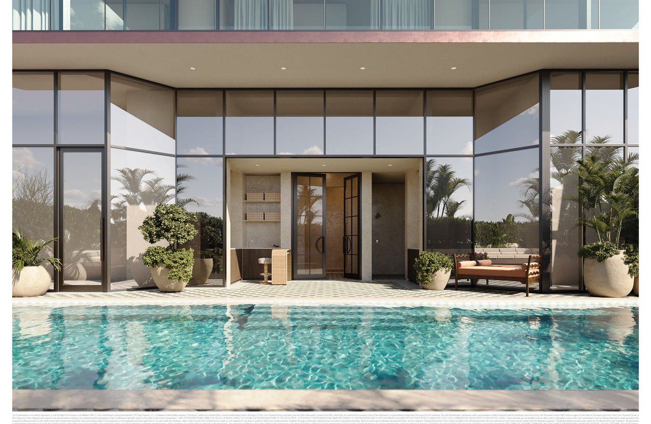 Modern glass-fronted residence beside a turquoise pool, with tropical plants and outdoor seating.