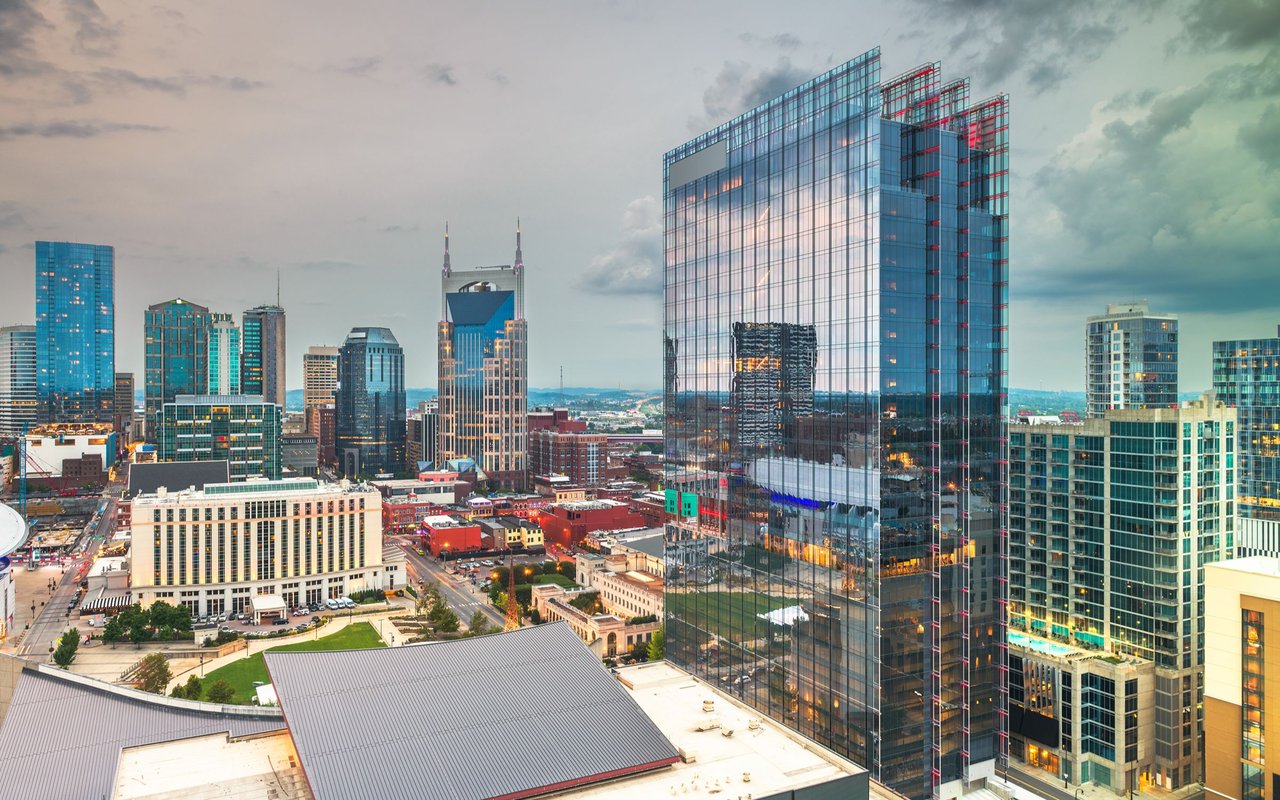 Downtown Nashville skyline with the AT&T “Batman” Building and a glass tower in the foreground.