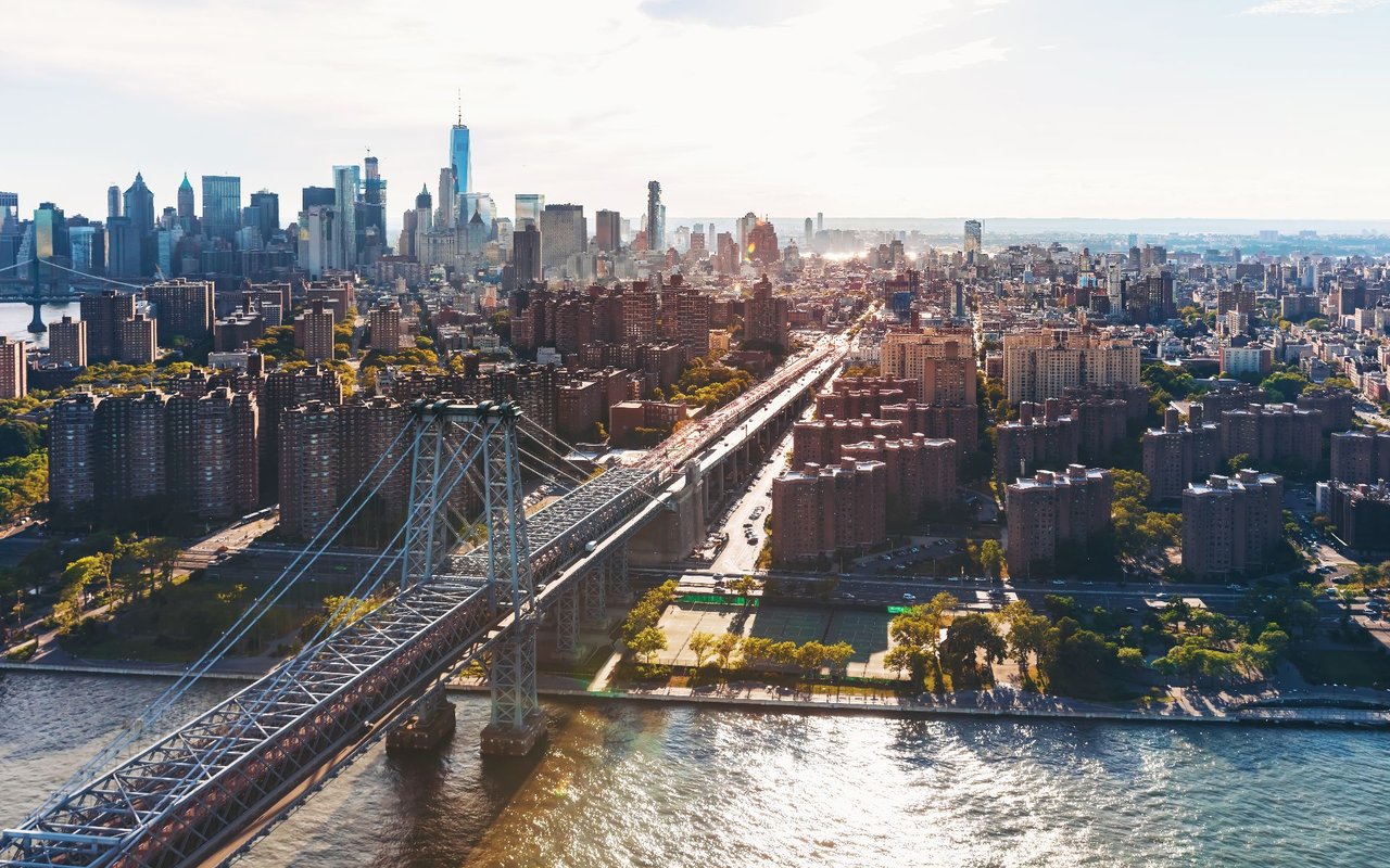 Aerial view of Williamsburg and the East River, with the Williamsburg Bridge and Manhattan skyline.