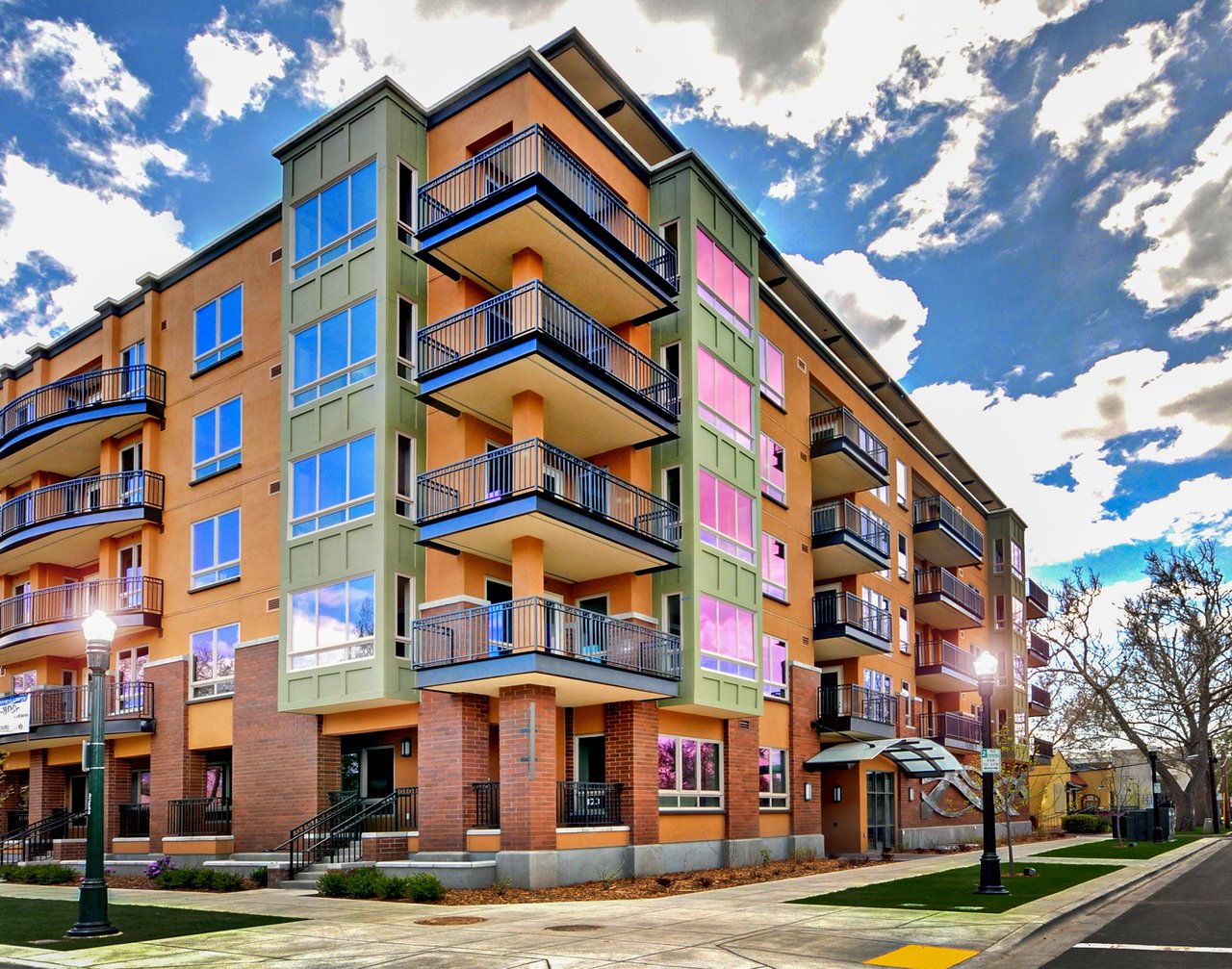 The Jefferson apartment building with projecting balconies and orange and green exterior panels.