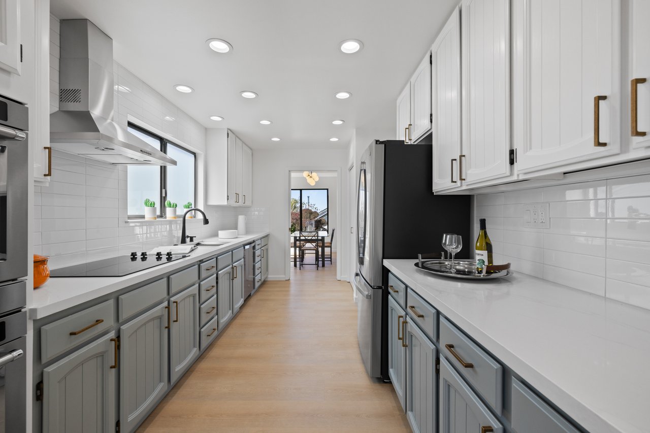 after image of kitchen with new countertop and painted cabinets