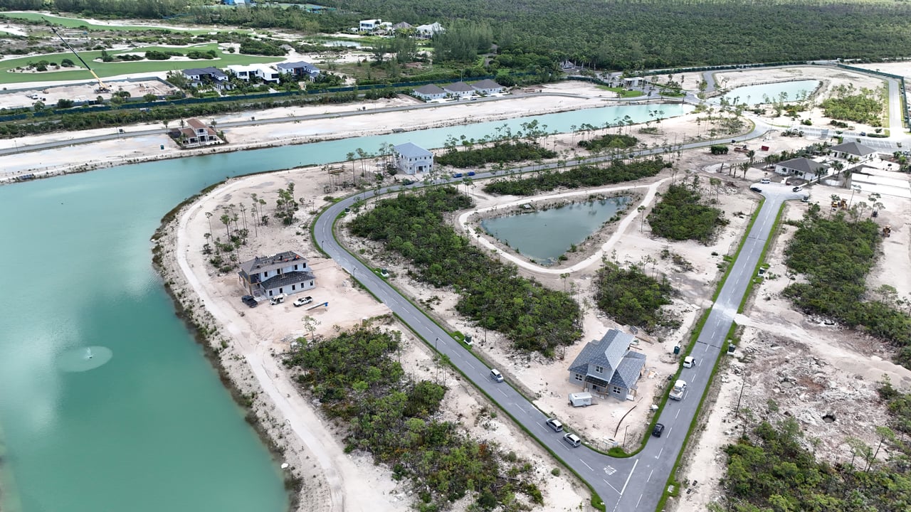 Aerial view of Windsor Lakes gated community showing completed homes, lakes, and available lots in Nassau, Bahamas
