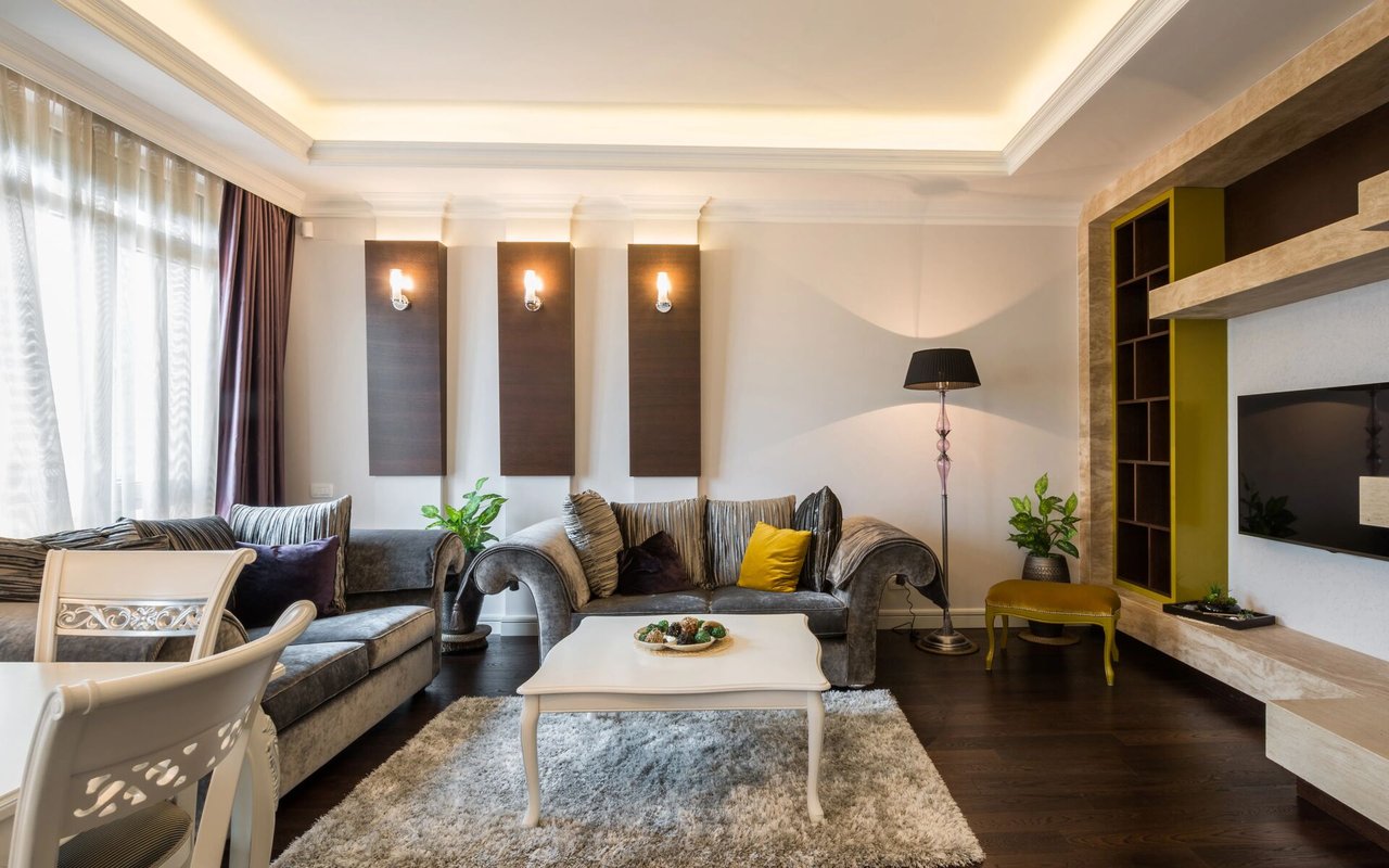 Living room with gray sofas, a white coffee table, and a built-in entertainment unit.