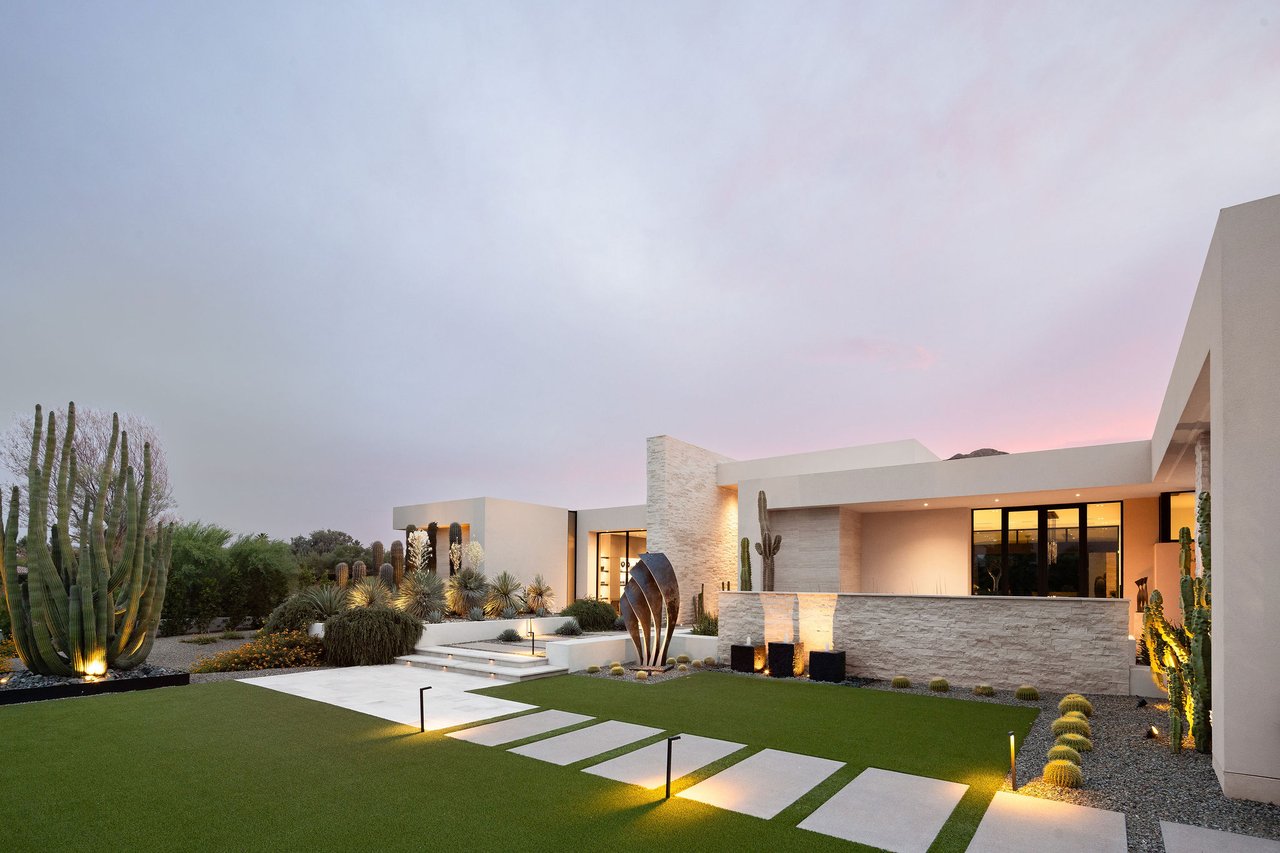 Modern luxury home in Paradise Valley with resort-style backyard, pool, fire feature, and contemporary architecture at sunset.