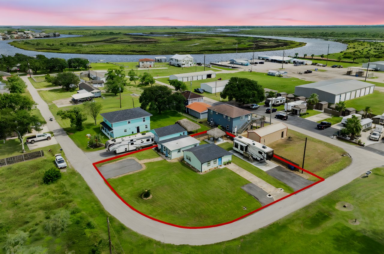 Exterior view of investment property at 4402 Zelsky Rd, Freeport TX featuring two rental homes and RV pad.