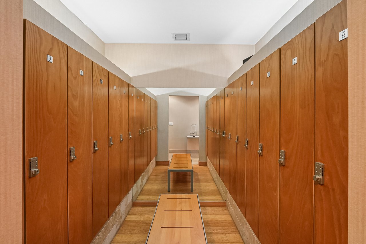 Wood lockers and bench in the resident locker room at Jade Residences at Brickell Bay