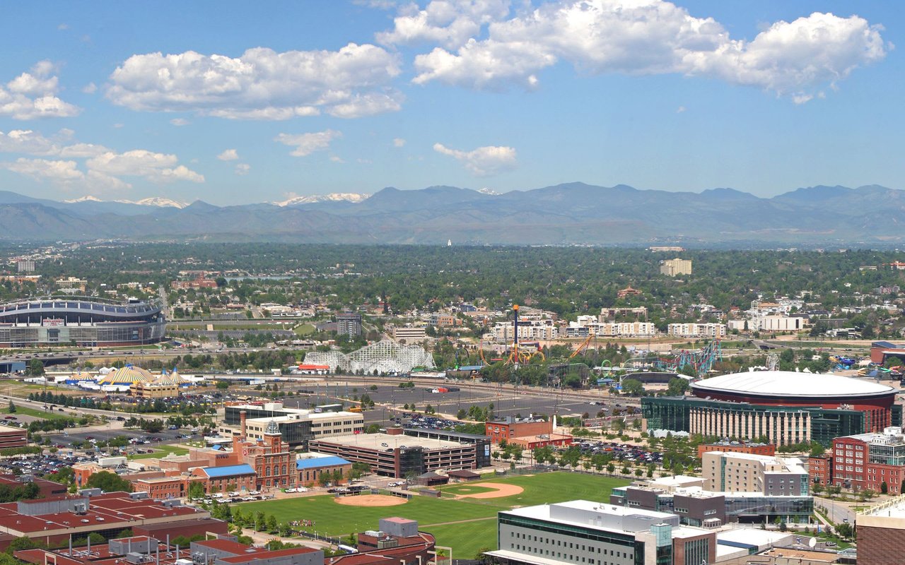 An aerial view of a city with mountains in the background