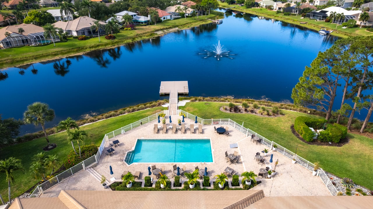 Aerial shot of Longshore Lake community pool with lakefront views in North Naples