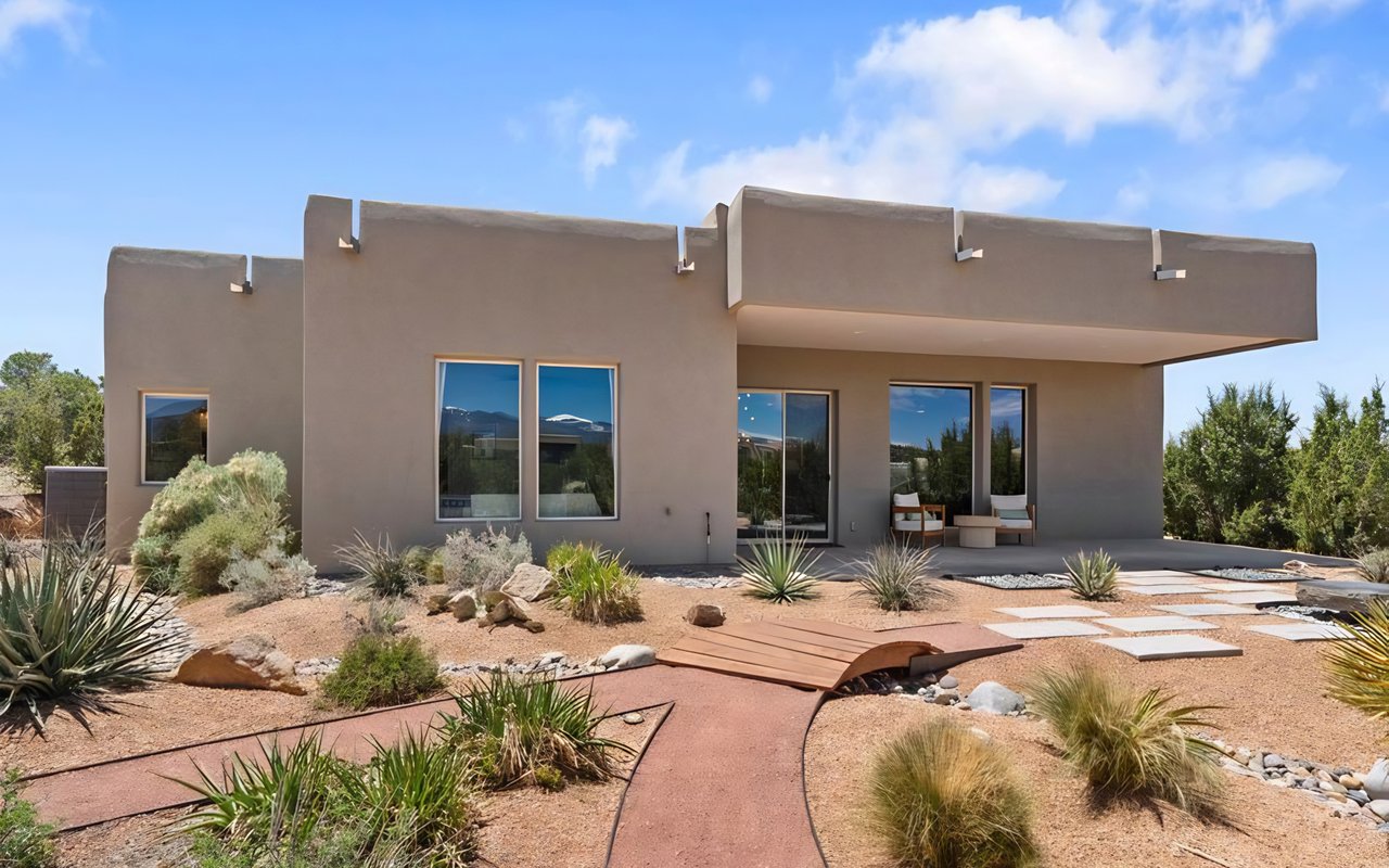 Modern Southwestern home with a covered patio and desert landscaping.