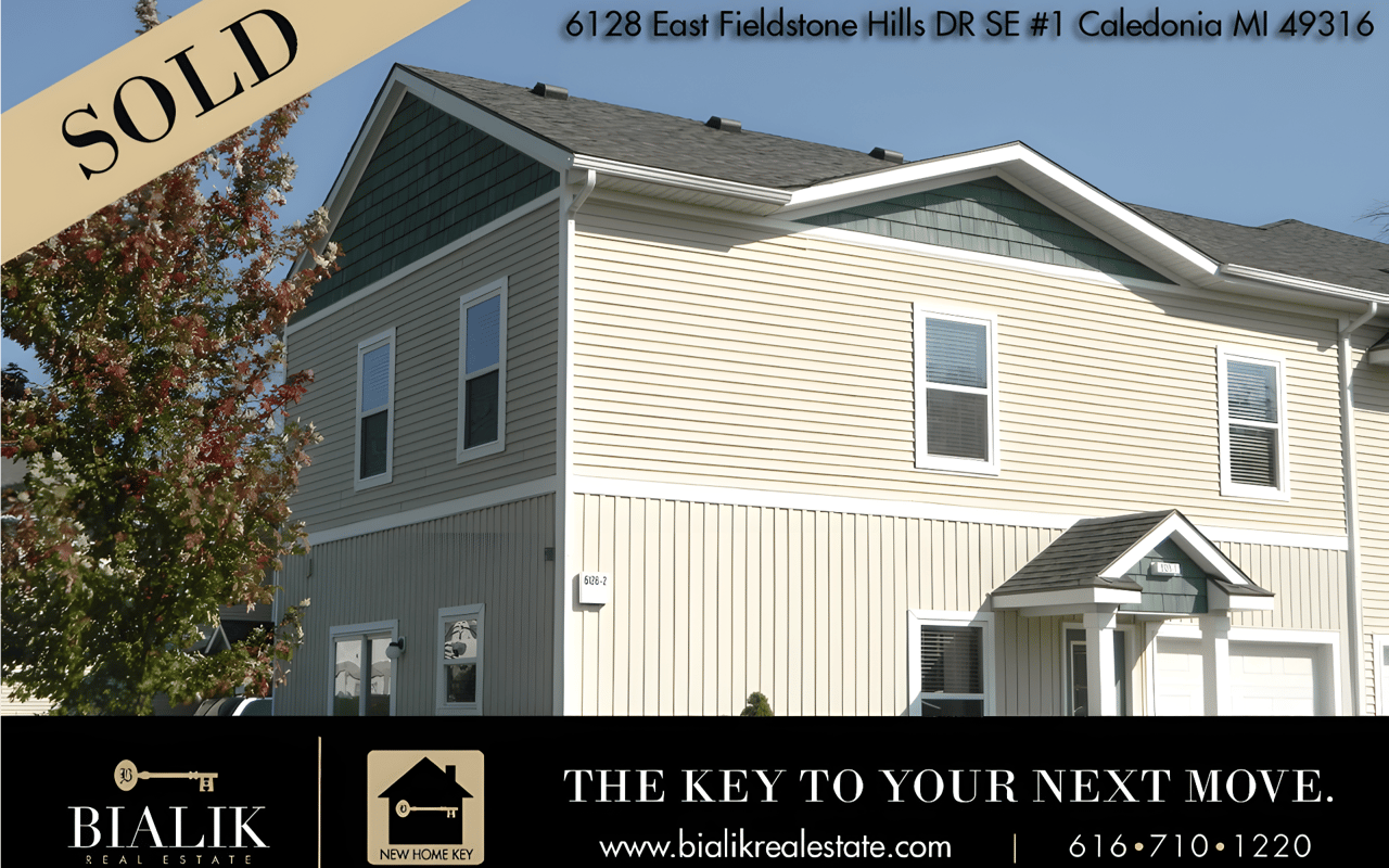 Two-story beige home with green gables, marked sold at 6128 East Fieldstone Hills Drive.