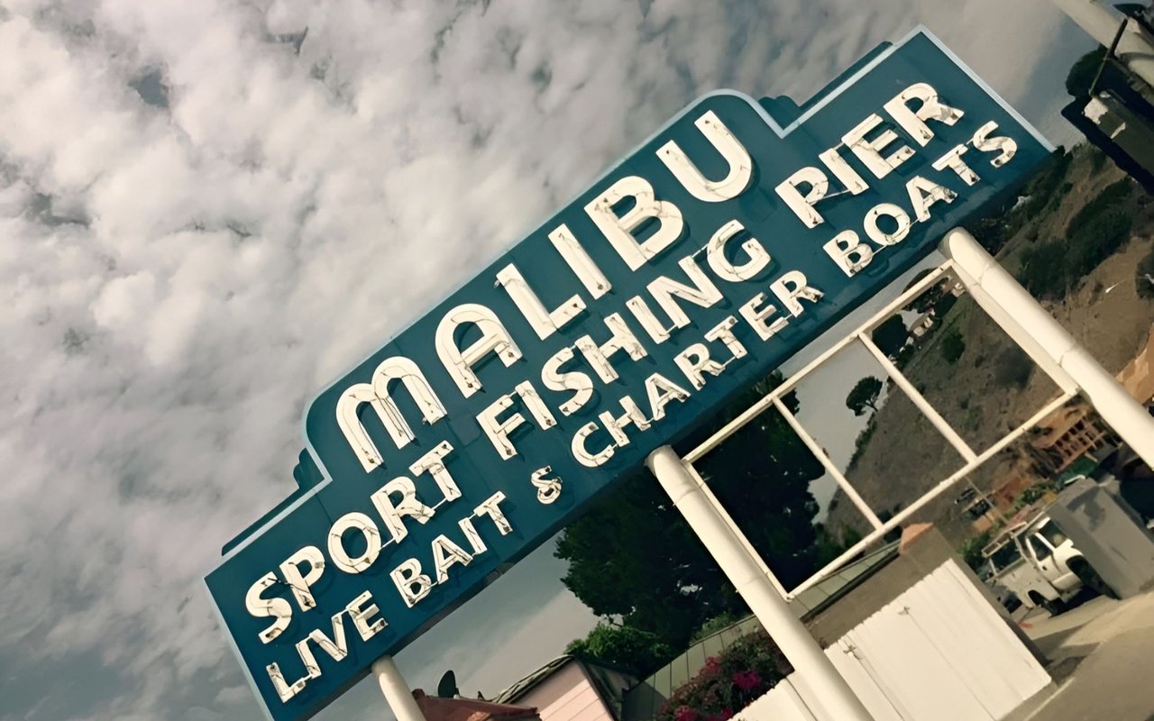 Malibu Sport Fishing Pier sign advertising charter boats and live bait.
