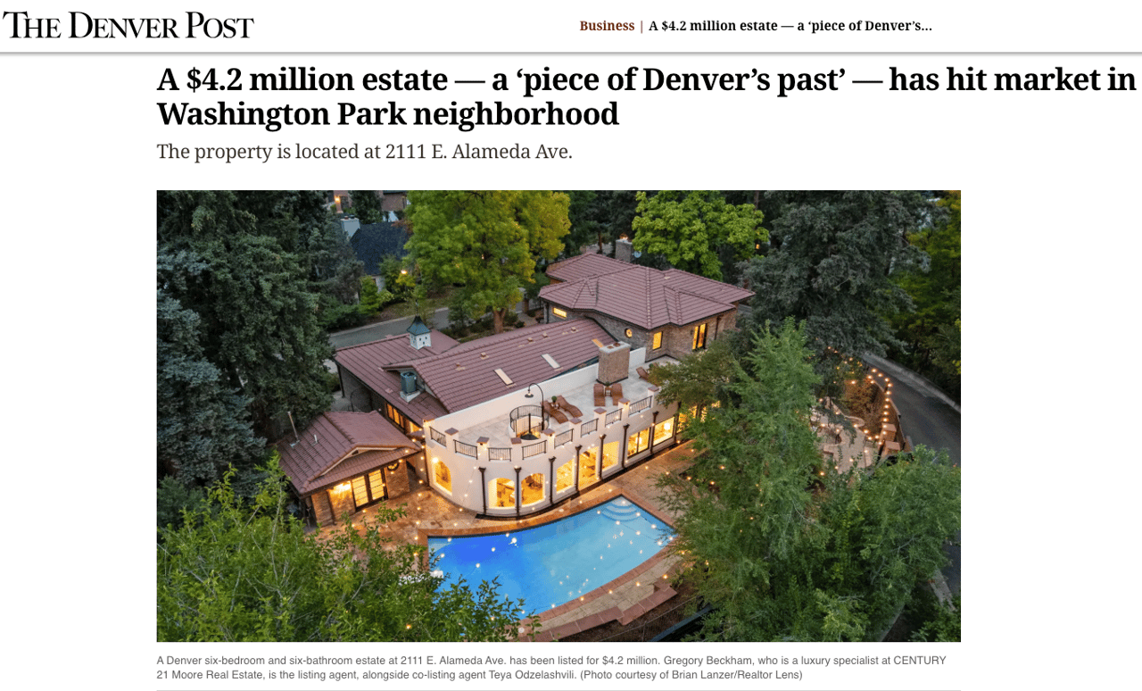 Denver estate at dusk with red tile roofs, a curved terrace, and a lit swimming pool.