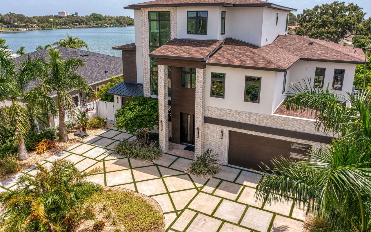 Modern two-story home with a patterned driveway and lake views.