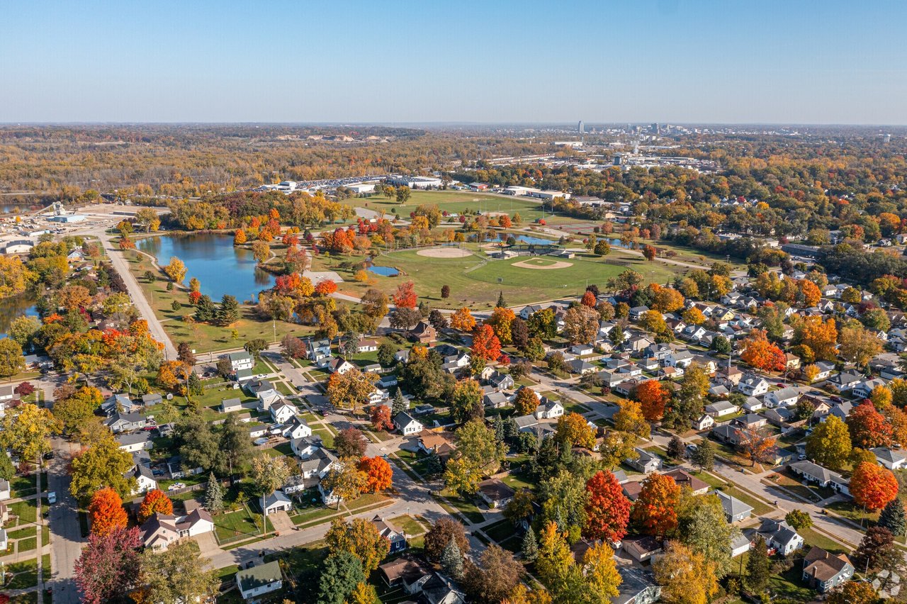 Aerial view of Wyoming Park in Wyoming Michigan with baseball fields, a pond, and surrounding neighborhoods in autumn.
