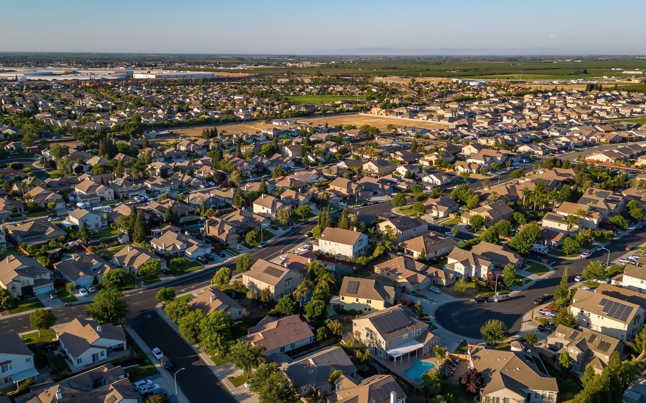 Aerial view of Manteca homes and streets, with farmland on the horizon.