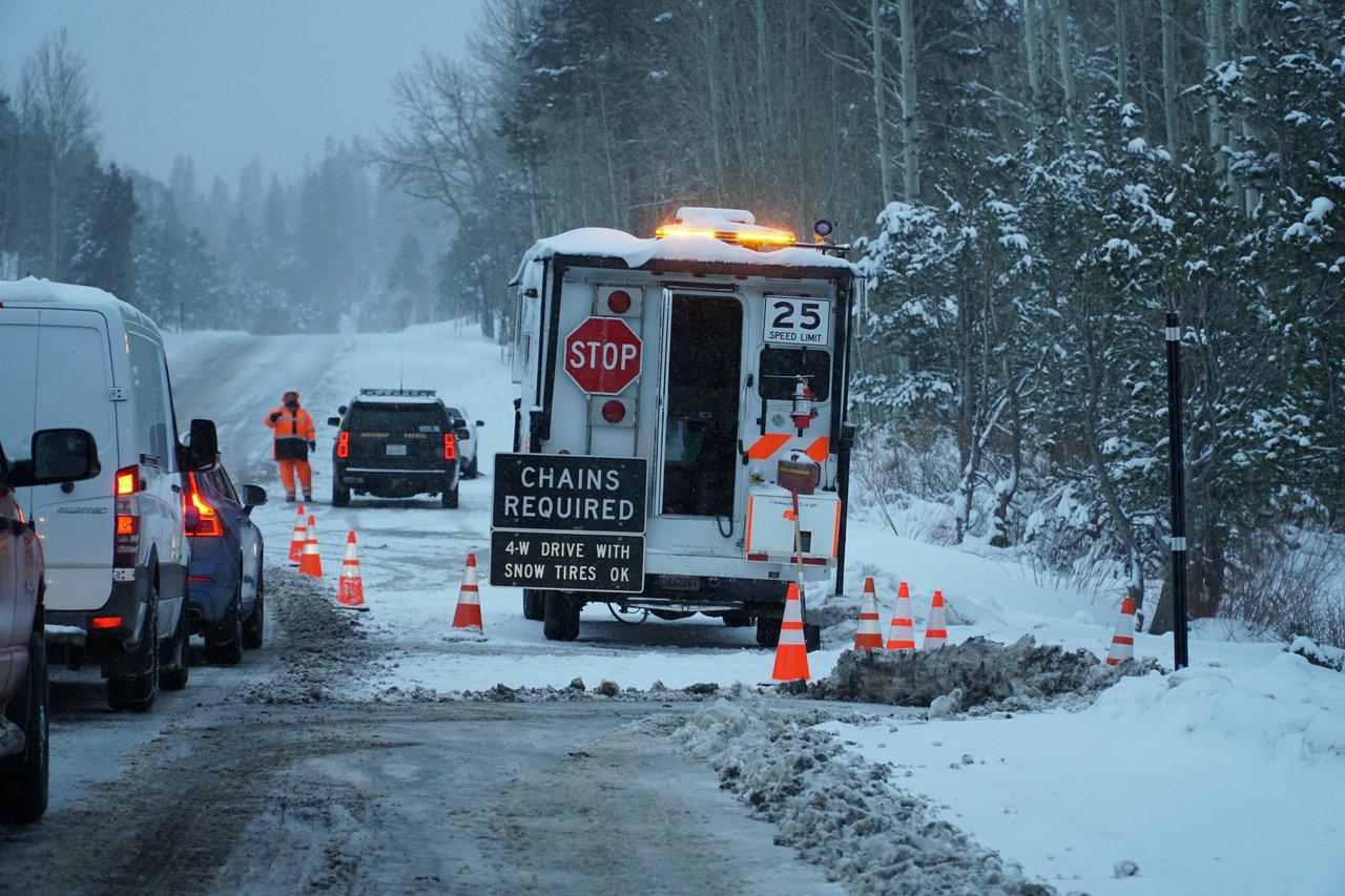 A snow-covered road in Lake Tahoe with heavy snowfall and low visibility, highlighting dangerous winter travel conditions.