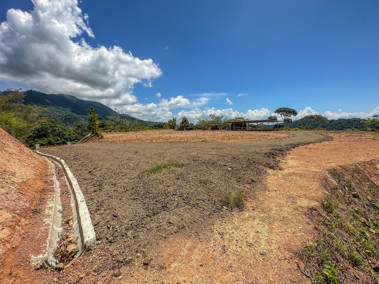 An elevated, prepared river lot with 360-degree ocean, mountain, valley and jungle views