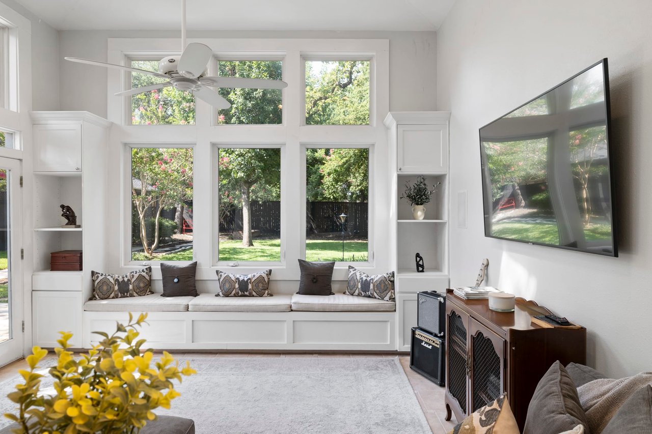 Sunroom with vaulted ceilings, a built-in window seat, and a wall of windows, 2404 Westover Rd.