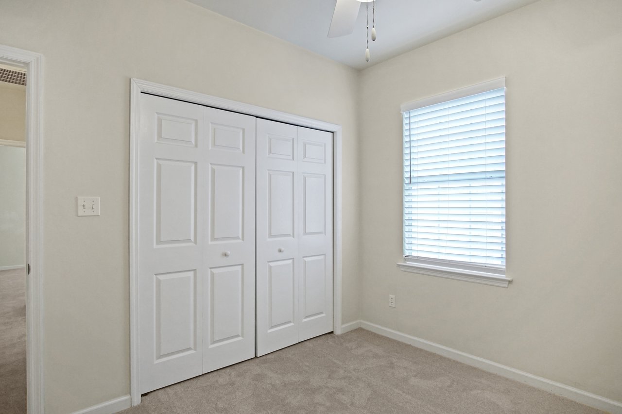 Bedroom at 5441 Hampton Hill Circle, Tallahassee, Florida 32311 featuring window with blinds, ceiling fan, and double closet doors.