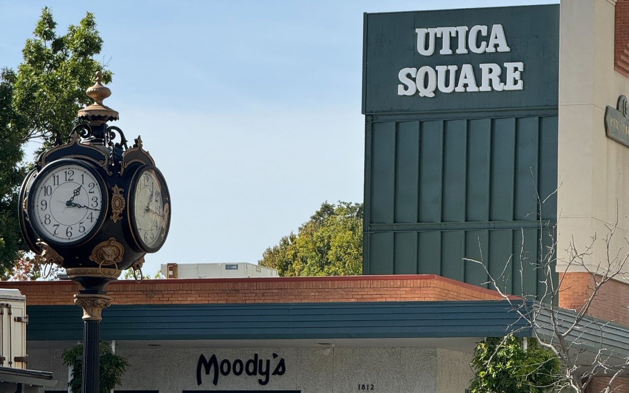 Utica Square entrance with an ornate street clock and Moody's storefront.
