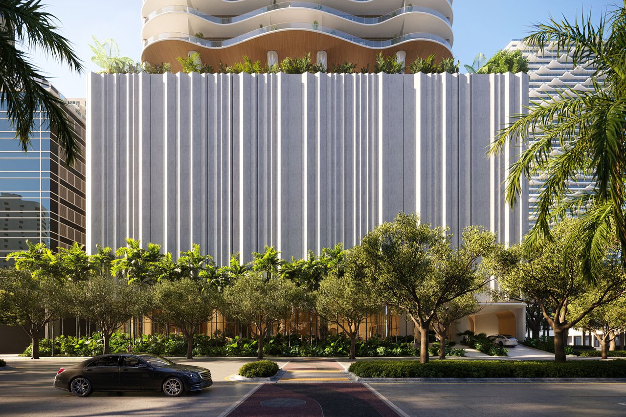 1428 Residences tower with a ribbed facade, curved balconies, and landscaped street frontage.