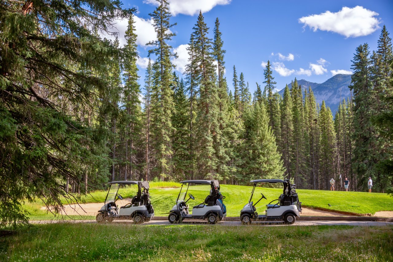 Aerial view of a luxury country club community in Jackson Hole, WY, featuring a scenic golf course, mountain views, and upscale homes.