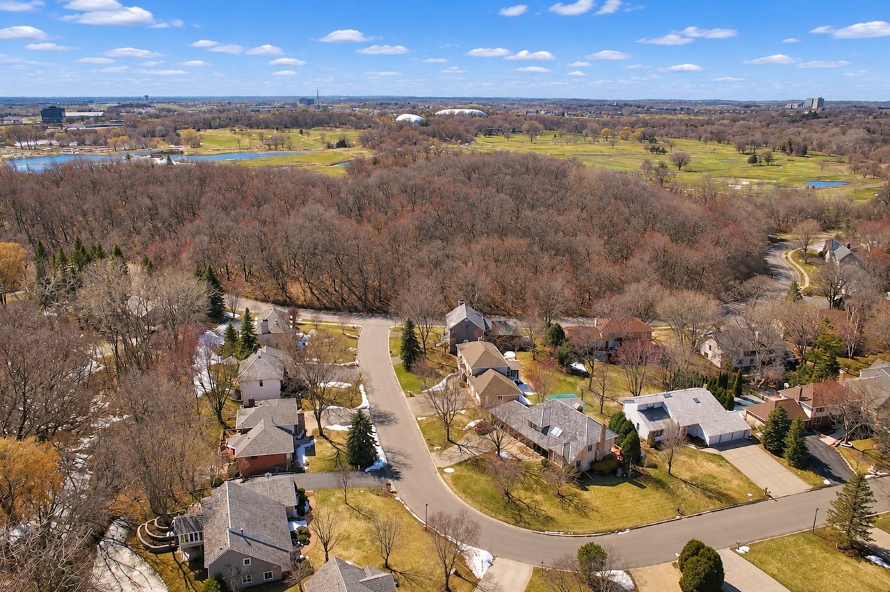 Aerial view of homes in Edina's Dewey Hill neighborhood, featuring Braemar Woods & Golf Course, tree-lined streets, landscaped properties, and residential architecture.