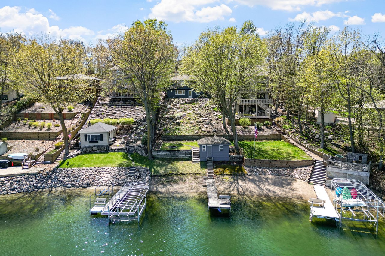 rear view of a home and boat dock of a lake property in the Twin Cities MN sold by A Good Life Group real estate team