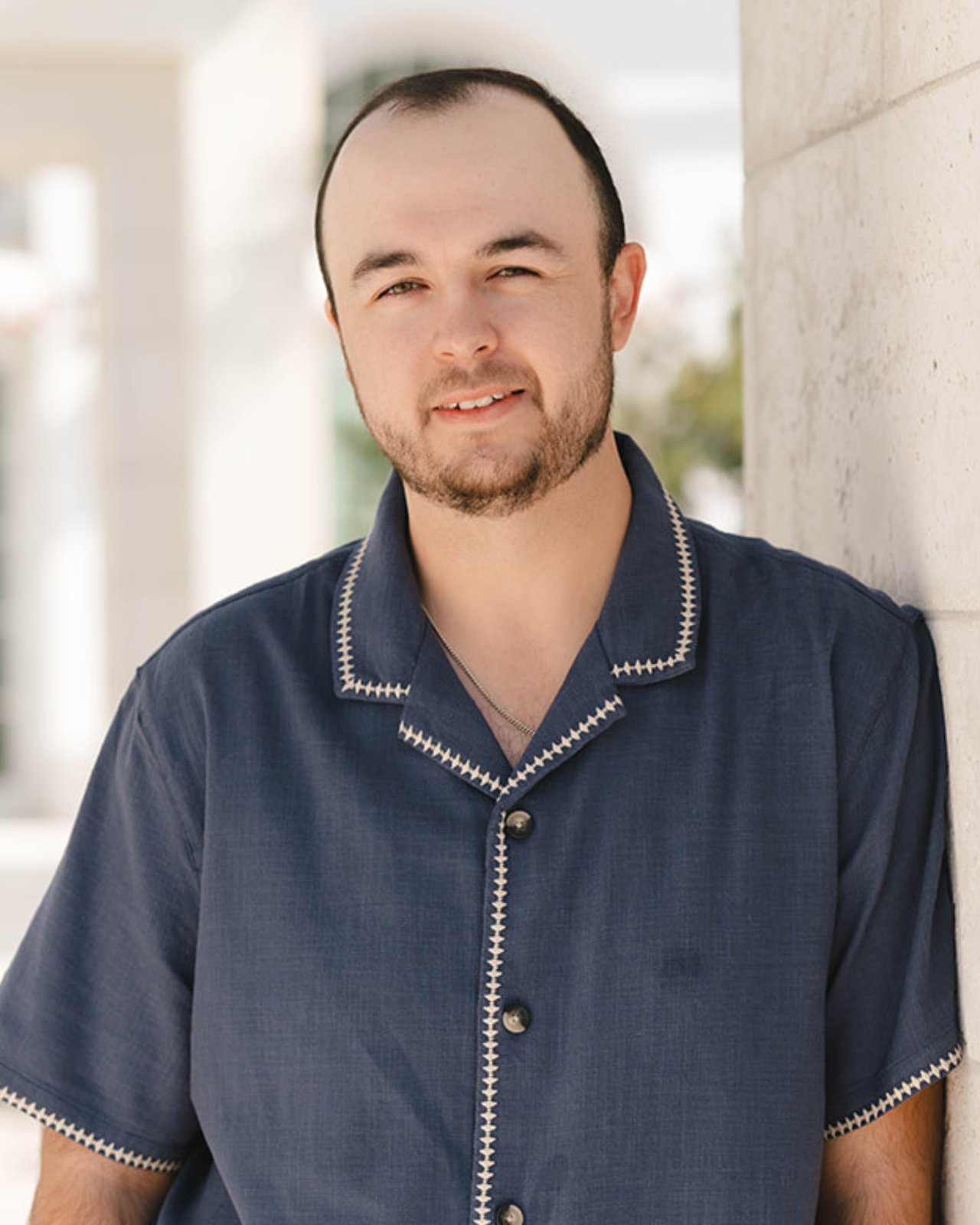 Nevan Farias, real estate advisor with The Kendall Hood Collection, smiling in professional headshot